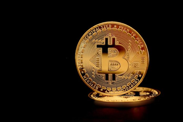 Photo by Daniel Dan Close-Up Photograph of a Gold Bitcoin