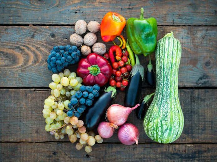 Photo by Dan Cristian Pădureț a variety of fruits and vegetables on a wooden surface