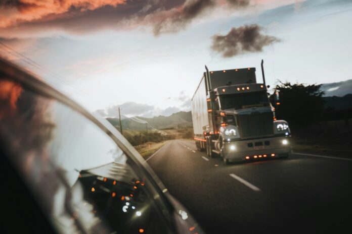 Photo by Josiah Farrow red truck on road during daytime