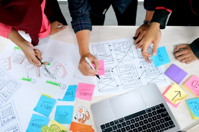 Photo by UX Indonesia person writing on white paper