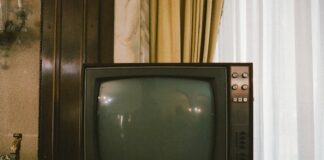 turned-off gray CRT TV on table