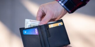 The Benefits of Credit Repair Companies: How They Can Save You Money black leather bifold wallet on persons hand