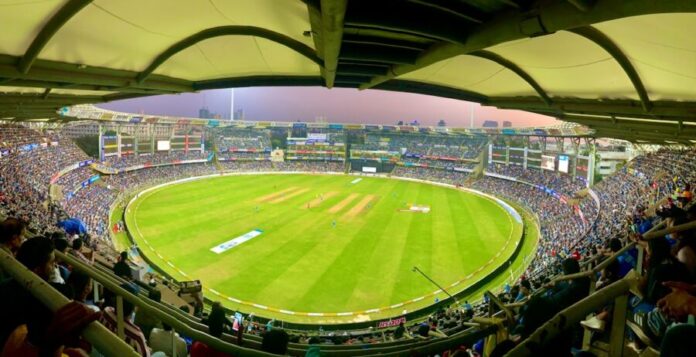 Photo by Ajay Parthasarathy people watching football game during daytime