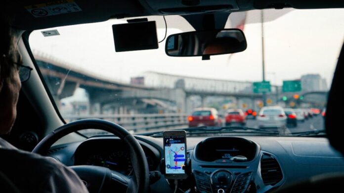 Photo by Dan Gold man driving vehicle with GPS system turned on