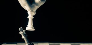 grayscale photo of person holding glass