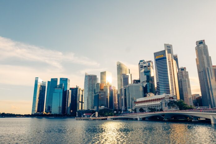 Photo by CHUTTERSNAP a large body of water with a city in the background