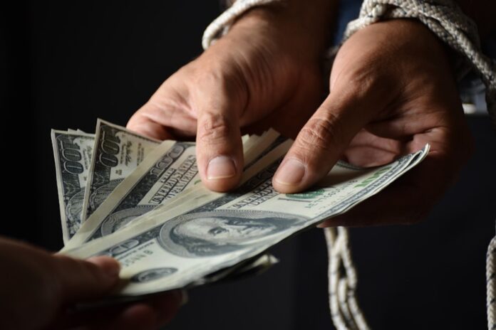 Photo by Nohe Pereira person holding 100 us dollar bill