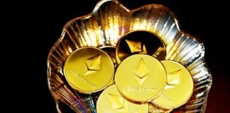 gold and silver round coins on clear glass bowl