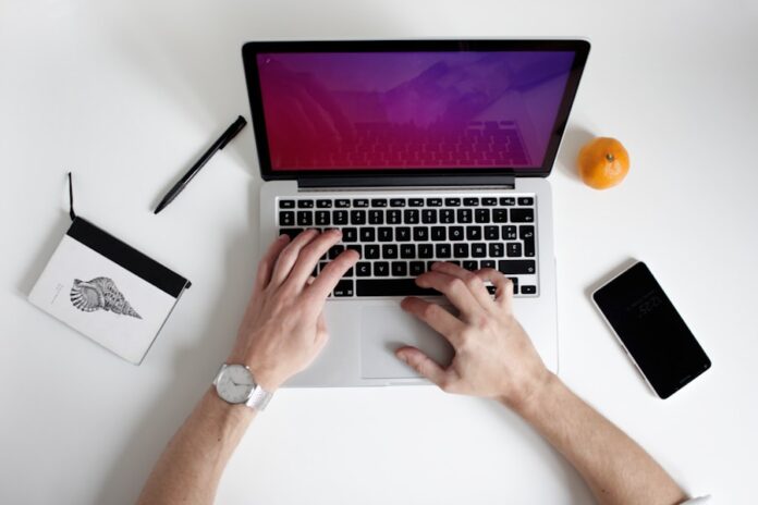 Photo by NordWood Themes person using laptop computer