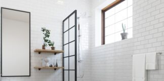 a bathroom with a toilet, sink, and shower