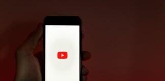 Hand Holding Smartphone with Internet Access to YouTube