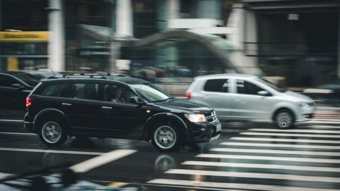 Photo by Kaique Rocha Black Suv Beside Grey Auv Crossing the Pedestrian Line during Daytime
