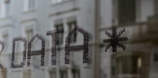 a close up of a window with a building in the background
