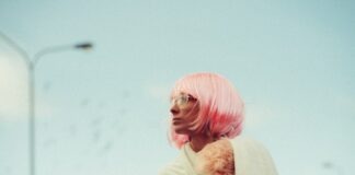woman looking sideways near light post