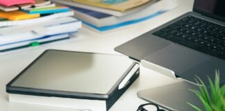 a laptop computer sitting on top of a white desk