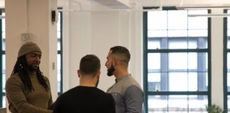a group of men standing around each other in a room
