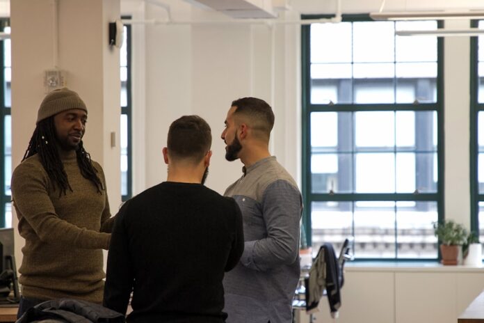 Photo by The Jopwell Collection a group of men standing around each other in a room