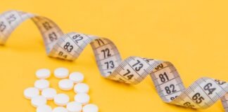 white round medication pill on yellow surface
