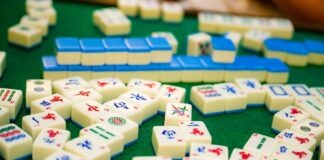 Exploring the Thrilling World of Mahjong Ways 2 Slot Game Close-up of colorful mahjong tiles on green felt, showcasing a variety of designs and symbols.