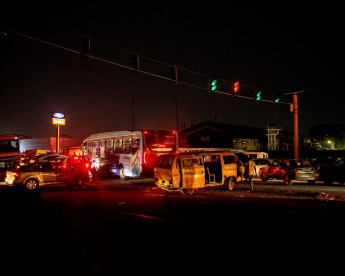 Photo by David Iloba A crowded urban nighttime scene featuring a traffic accident at a busy intersection.