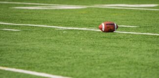 A football laying on a football field