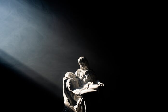 Photo by Grant Whitty man in white and black jacket and pants sitting on black surface