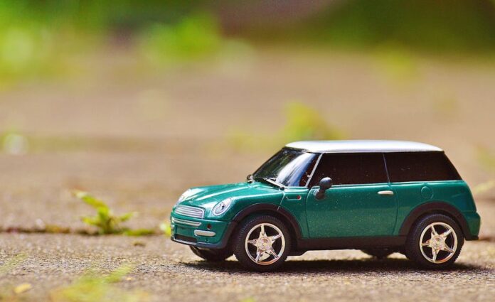 Photo by Pixabay Green toy Mini Cooper car on pavement featuring a shallow depth of field outdoors.