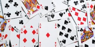 A collection of scattered playing cards showcasing various suits and numbers for casino themes.