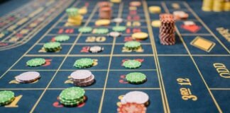Close-up of a roulette table with colorful poker chips, capturing the thrill of casino gambling.