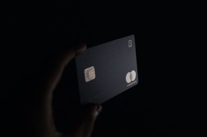 Photo by Ales Nesetril person holding black card