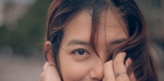 selective focus photography of woman covering her face