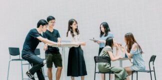 two men and four women meeting in office