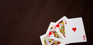 The Definitive Guide to Finding the Best Casino Bonuses in 2025 Elegant flat lay of playing cards featuring ace of hearts on a wooden surface.