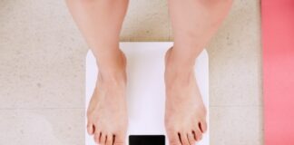 person standing on white digital bathroom scale