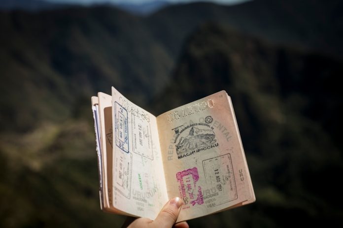 Photo by Agus Dietrich person holding passport
