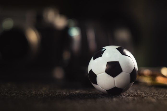 Photo by Konstantin Evdokimov white and black soccer ball on black sand