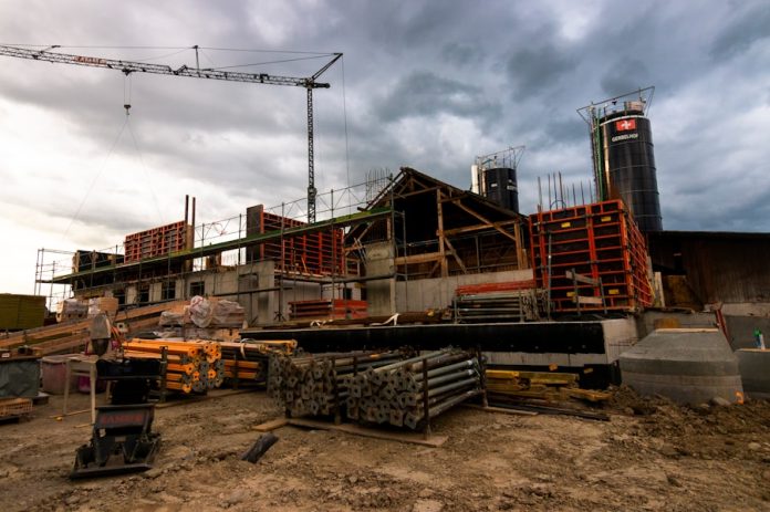 Photo by Jan Huber a construction site with a crane in the background