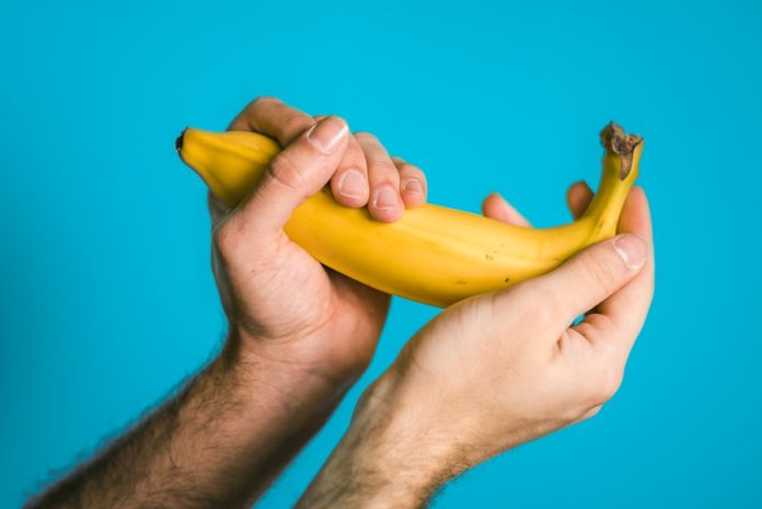Photo by Scott Sanker person holding banana