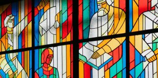 man reading stain glass window