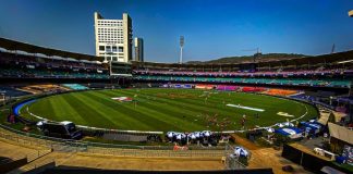 a sports field with a crowd of people in the stands