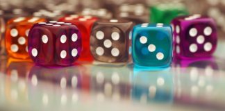 Colourful clear dices on a glass surface