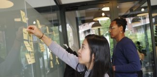 woman in gray long sleeve shirt hugging man in blue long sleeve shirt