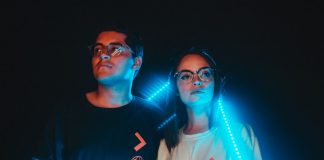 couple standing near neon light