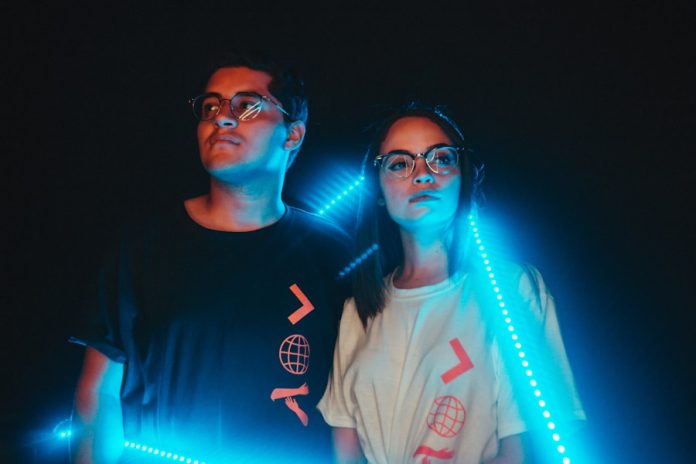 Photo by Efren Barahona couple standing near neon light