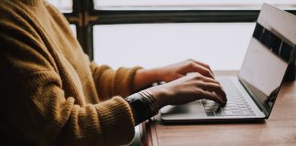 person sitting front of laptop
