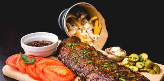 roasted ribs with sliced tomatoes and potatoes