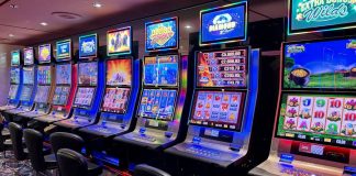 Bright casino slot machines with colorful displays and no people present.
