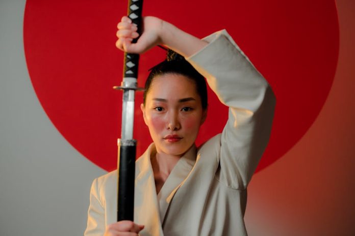Photo by cottonbro studio A striking portrait of a resilient woman in a blazer holding a katana, emphasizing strength and elegance.