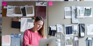woman in red long sleeve shirt sitting in front of silver macbook