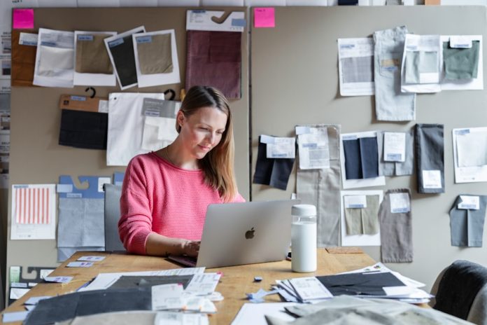 Photo by LinkedIn Sales Solutions woman in red long sleeve shirt sitting in front of silver macbook